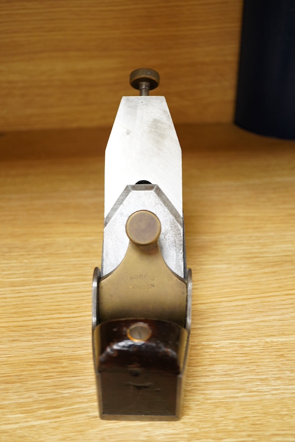 A Norris adjustable smoothing plane, stamped with Norris, London to the brass lever cap, with replacement iron, owner’s name lightly stamped to both sides of the handle, the front infill with a screw inserted down throug